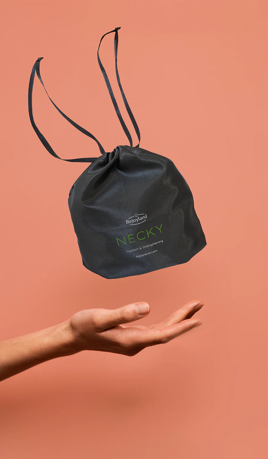 A small drawstring bag with the portable neck trainer labeled Bejoyland NECKY levitates above a hand.